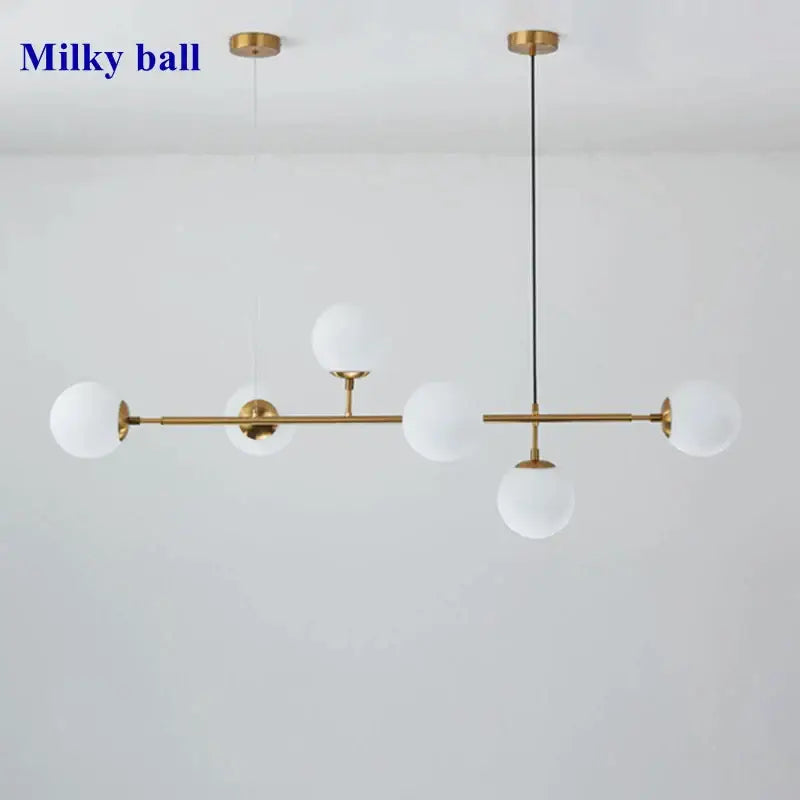 Modern gold glass ball pendant chandelier with five frosted white orbs suspended by rods and cords for dining room decorbites glass ball
