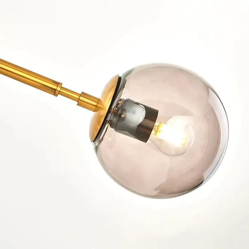 Modern gold glass ball pendant chandelier with smoked glass globe and brass accents for dining room decorbites glass ball