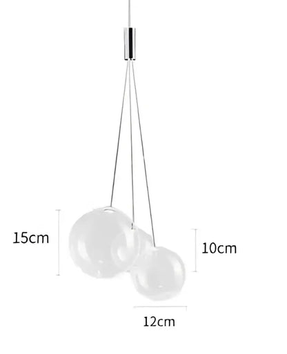 Modern gold glass ball pendant chandelier with three clear glass spheres suspended by thin metallic cords