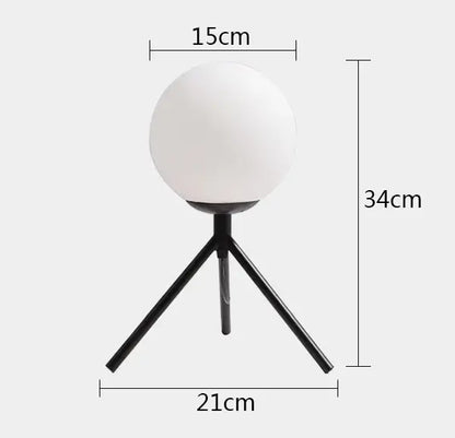 Modern gold glass ball table lamp with frosted globe light and black tripod base for stylish bedroom decorbites glass ball decor