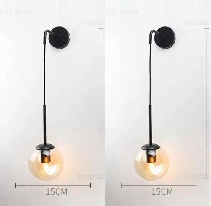 Black metal wall lamp with a hanging glass ball globe for modern bedroom decorbites glass ball sconce