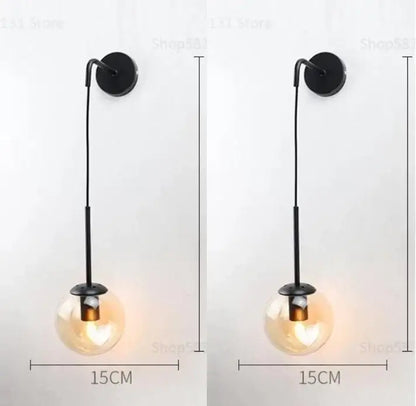 Black metal wall lamp with a hanging glass ball globe for modern bedroom decorbites glass ball sconce