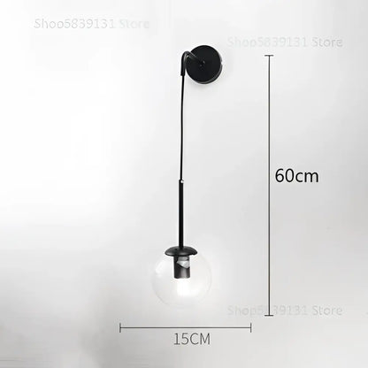 Modern gold glass ball wall lamp with black metal sconce and clear glass globe bulb for bedroom decorbites decor