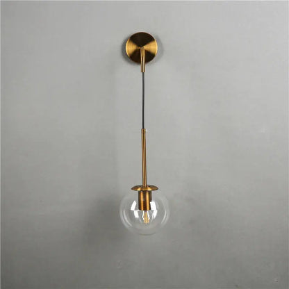 Modern gold glass ball wall lamp with brass finish and clear glass globe ideal for stylish bedroom decorbites glass ball