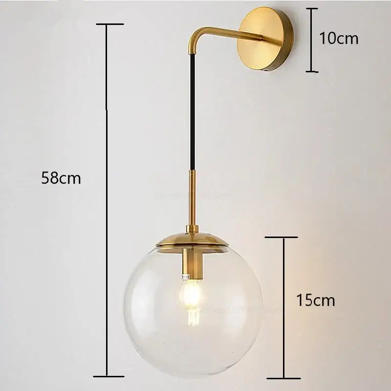 Modern gold glass ball wall lamp with brass finish, clear glass globe, and black accent rod for bedroom decorbites glass ball