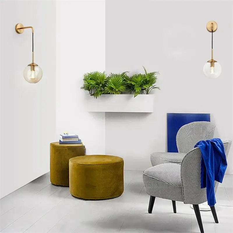 Modern gold glass ball wall lamp featuring a gold finish and clear glass globe shade for bedroom decorbites glass ball