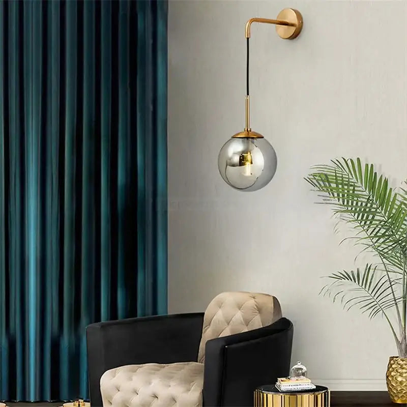 Modern gold glass ball wall lamp with sleek spherical glass pendant and gold-toned metal arm for bedroom decorbites glass ball