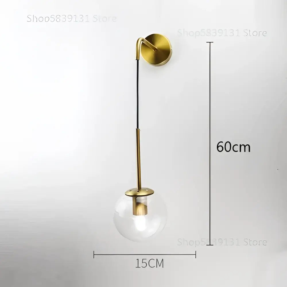 Modern gold wall lamp with a clear glass ball and slender metallic stem for decorbites glass ball bedroom sconce