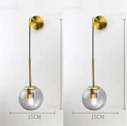 Modern gold glass ball wall lamp with clear glass globe and minimalist brass bracket perfect for bedroom decorbites glass ball