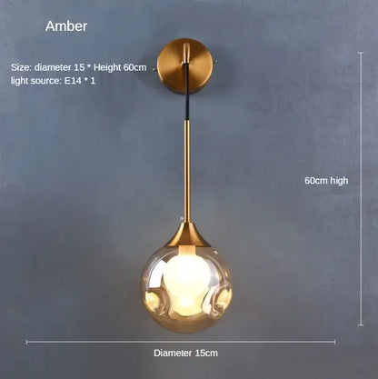 Modern gold glass ball wall lamp with a spherical amber glass globe and brass-finished decorbites glass ball mount