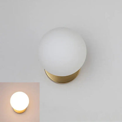 Modern gold glass ball wall lamp with frosted white glass globe and polished brass base for bedroom decorbites glass ball