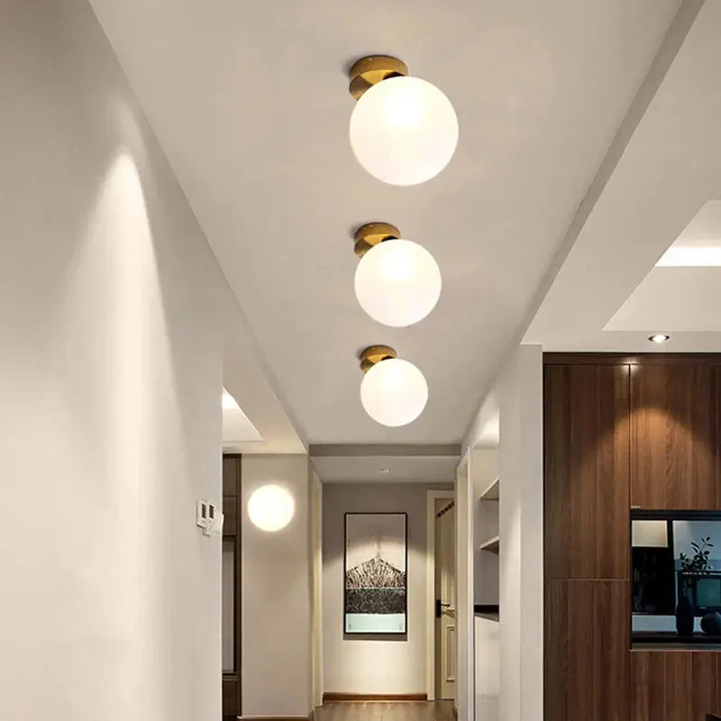 Three modern wall lamps with frosted glass ball shades and brass fixtures perfect for bedroom decorbites glass ball wall decor