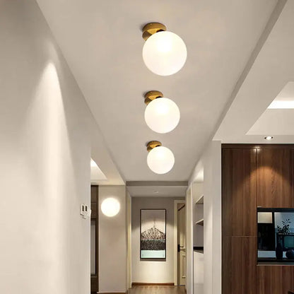 Three modern wall lamps with frosted glass ball shades and brass fixtures perfect for bedroom decorbites glass ball wall decor