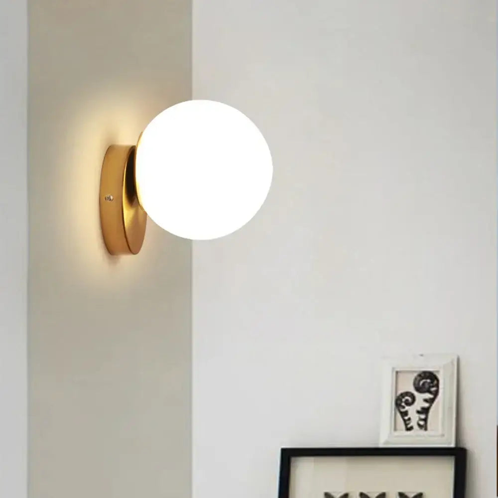 Modern gold glass ball wall lamp with frosted glass globe for bedroom featuring decorbites glass ball design wall lamp