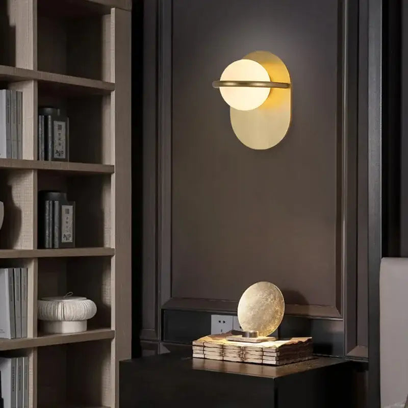 Modern gold glass ball wall light with sleek circular design and warm ambient lighting for bedroom decorbites glass ball