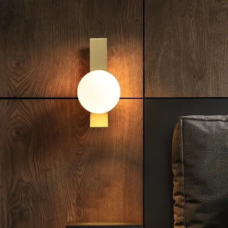 Modern gold glass ball wall sconce with matte gold rectangular backplate and frosted white glass ball lampshade decorbites glass ball