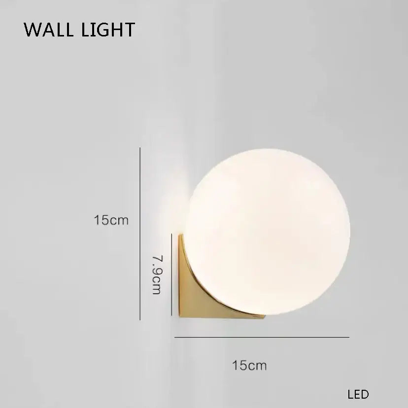 Modern gold glass balloon chandelier dining room light with a matte white glass globe on brushed gold bracket by decorbites glass balloon