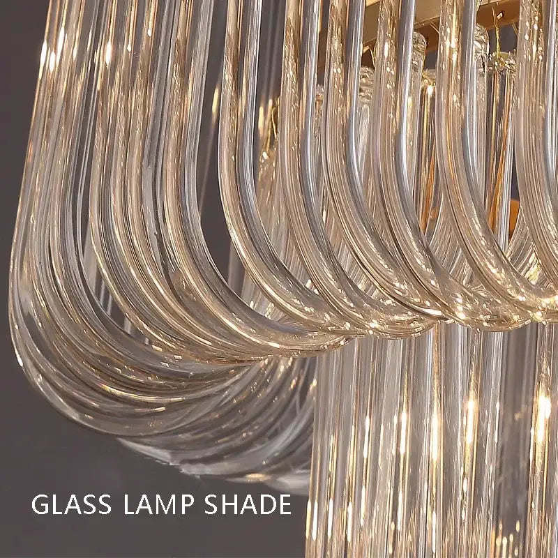 Curved transparent glass lamp shade with gold-toned accents in modern decorbites glass bar chandelier for luxury lighting