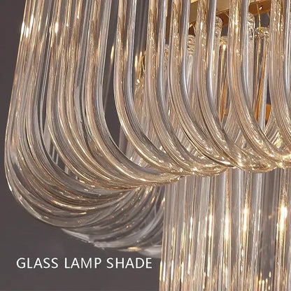 Curved transparent glass lamp shade with gold-toned accents in modern decorbites glass bar chandelier for luxury lighting