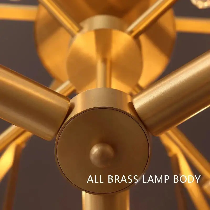 Modern gold glass bar chandelier with golden brass body featuring sleek geometric intersecting cylindrical arms decorbites glass bar
