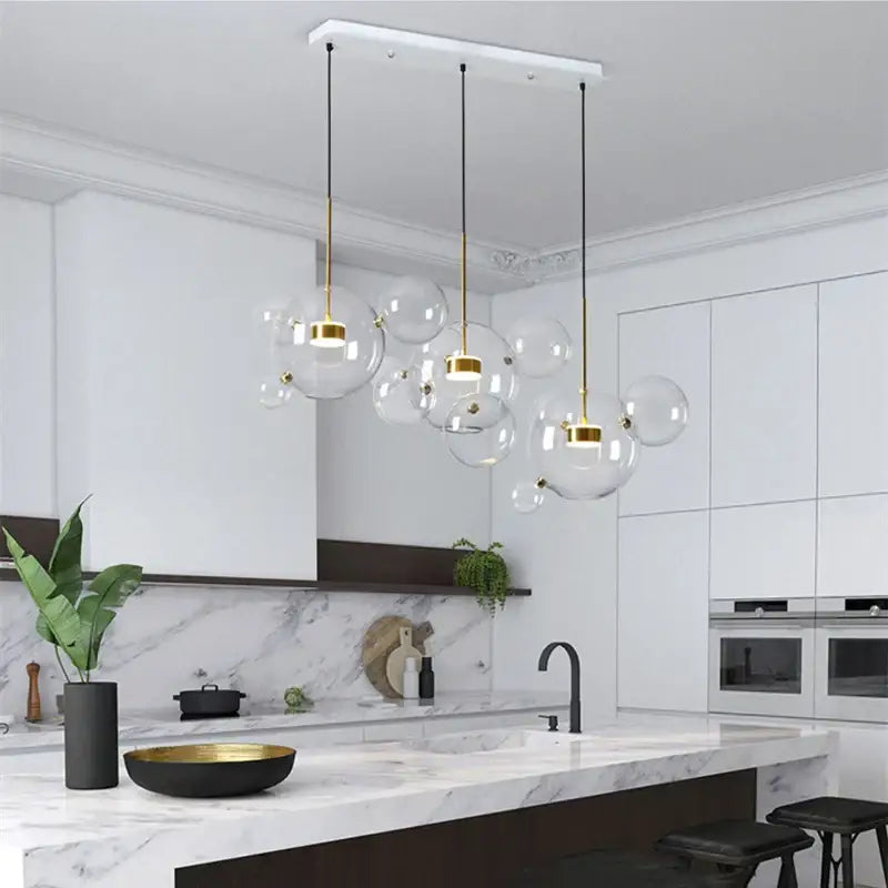 Modern gold glass bubble ball led chandelier with metal accents hanging from white ceiling fixture for dining room decorbites glass bubble