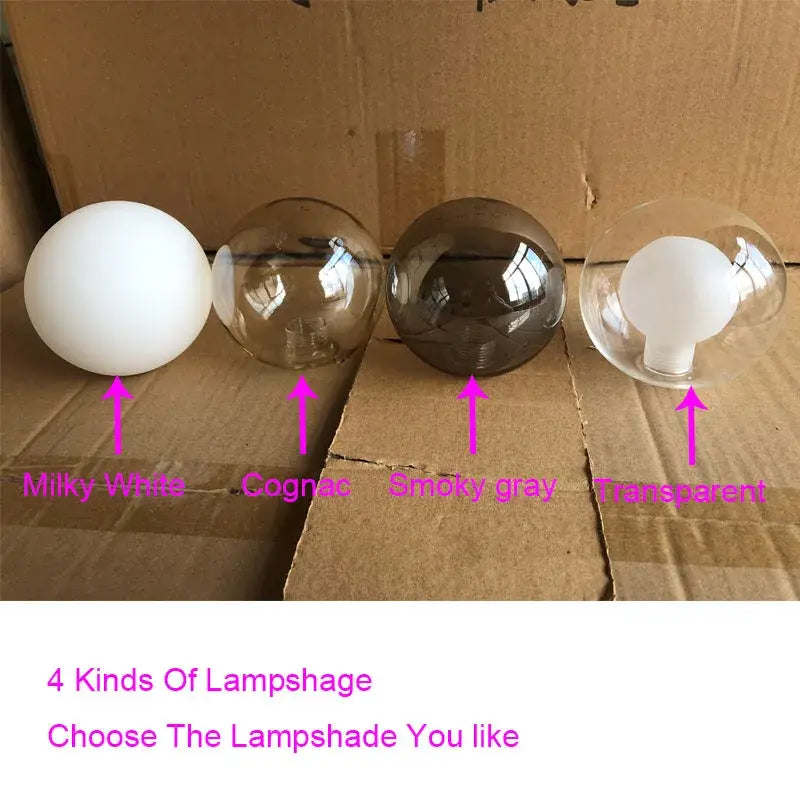 Modern gold glass globe pendant light with four spherical milky white cognac smoky gray and transparent lampshades metal structure