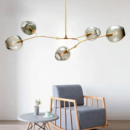 Modern brass pendant lights with five smoked glass globe shades ideal for dining room glass pendant lighting