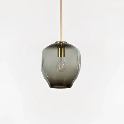 A sleek dark gray textured glass pendant light with brass fixture for modern gold glass pendant lights in dining room