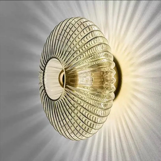 Modern gold glass ripple led wall lamps featuring a translucent ribbed glass sconce with a circular opening