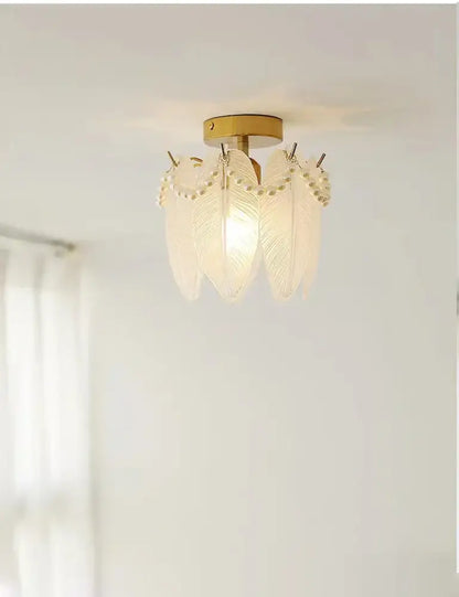 Modern gold glass shade ceiling light featuring a delicate translucent white feather glass pendant with pearl accents