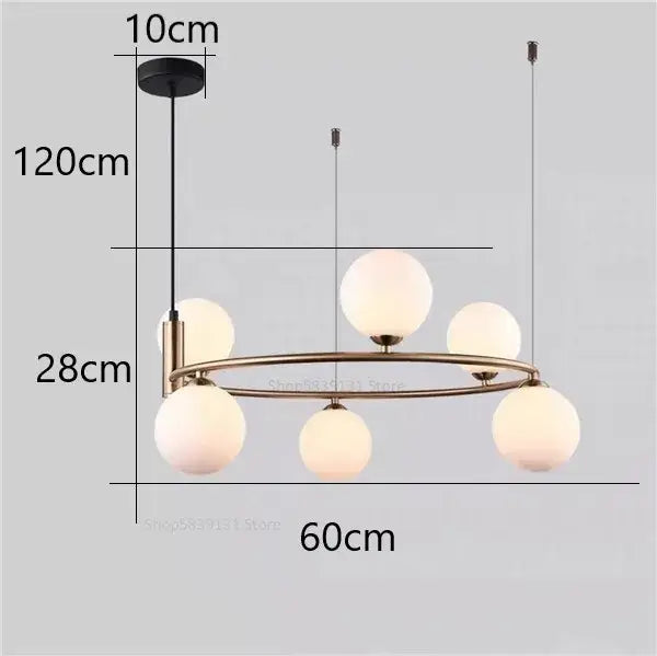 Modern gold brass-toned pendant light chandelier with five frosted glass globes for adjustable dining room lighting