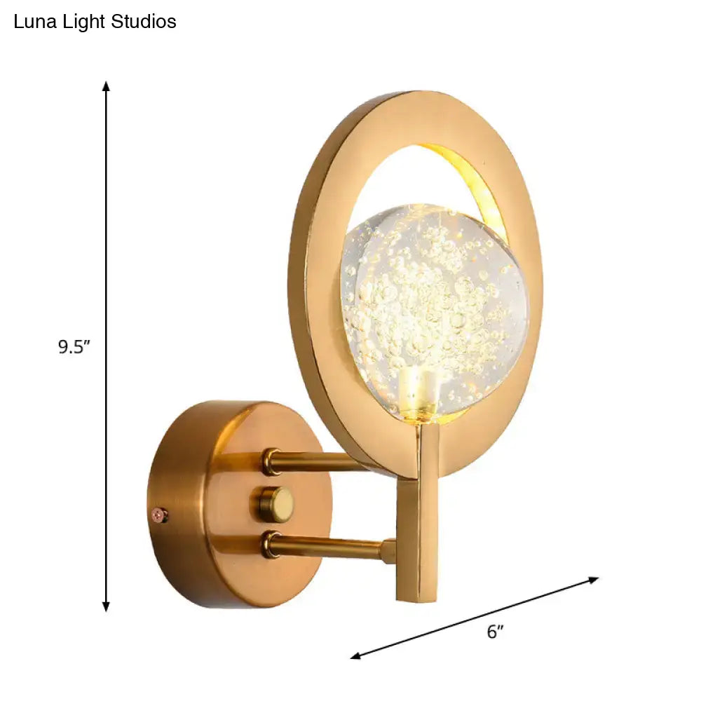 Modern gold globe wall lamp with clear crystal orb and floating light particles for bedroom 110v-120v use