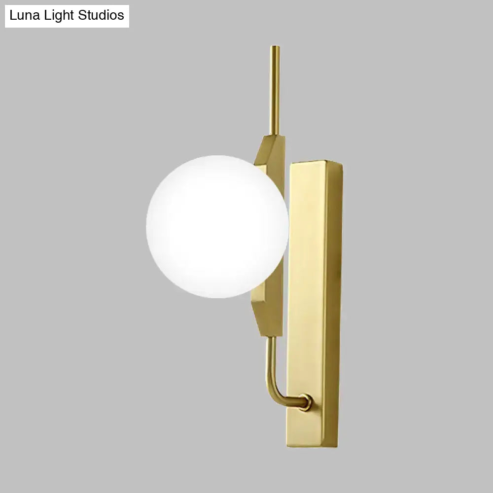 Modern gold globe wall sconce with a sleek rectangular backplate and frosted glass shade for 110v-120v use