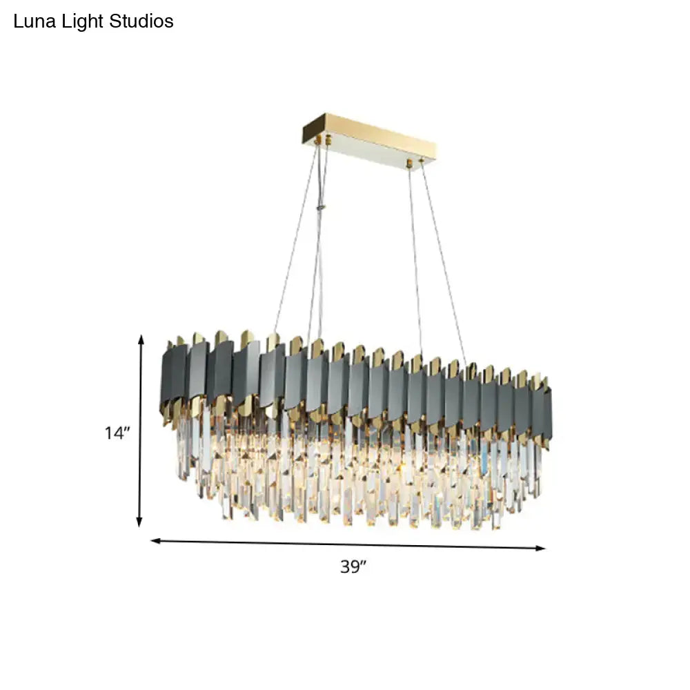 A modern gold and gray crystal light fixture chandelier with 220v-240v oval metallic panels and cascading prisms