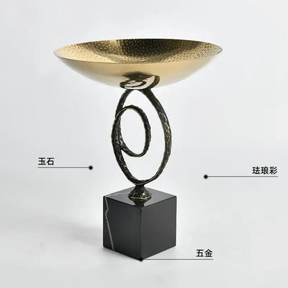 Modern gold hammered fruit bowl tray with twisted black metal stand and black marble base for dining room use