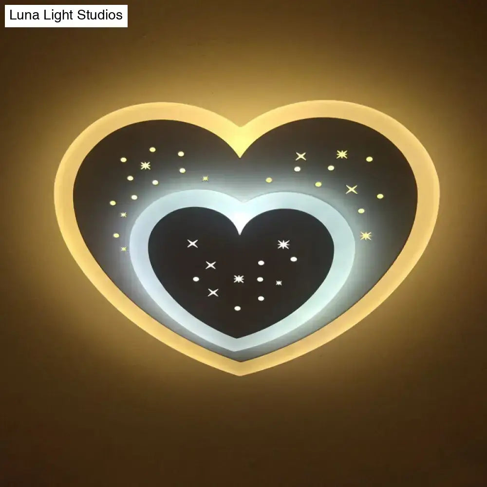 Modern gold heart pendant wall light with glowing rim and black starry center featuring rhombus star patterns for bedroom