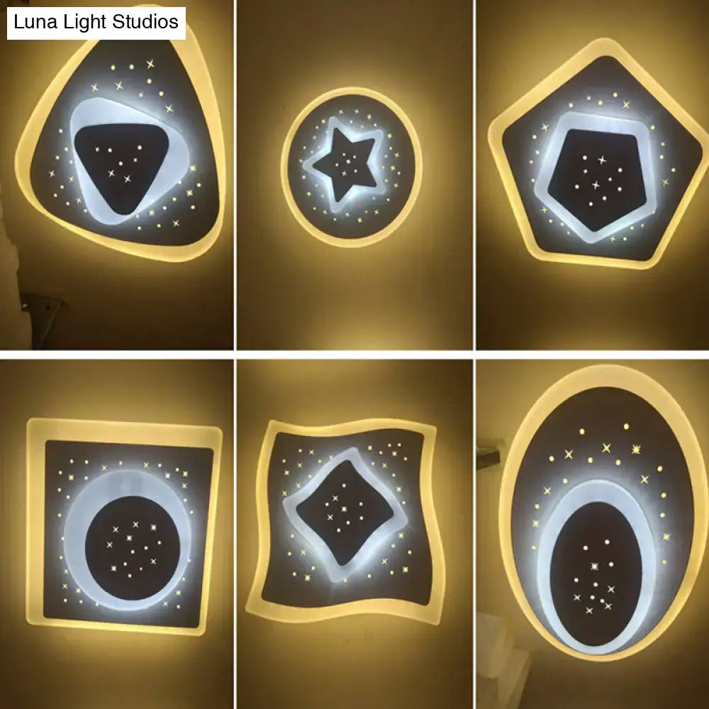 Modern gold heart pendant wall light with star-patterned black acrylic triangle rhombus cutouts and warm yellow backlighting