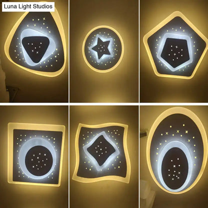 Modern gold heart pendant wall light with star-patterned black acrylic triangle rhombus cutouts and warm yellow backlighting