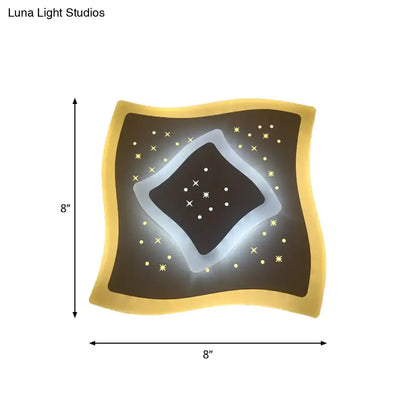 Modern gold heart pendant wall light with glowing white starburst rhombus star pattern on dark brown center panel
