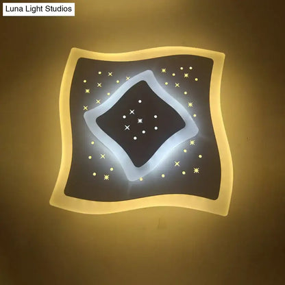 Modern gold heart pendant wall light with dark starry black center and warm edges featuring a rhombus star design