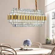 Modern gold icicle chandelier with 16 light bulbs featuring clear crystal prisms and braided rope suspension