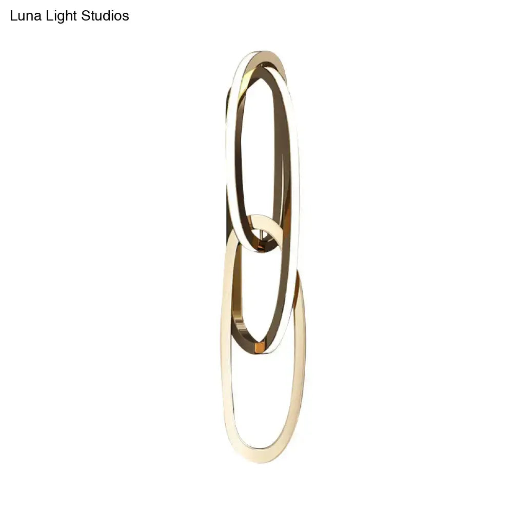 Modern gold interlocking oval led wall lamp with sleek minimalist gold-toned oval rings for living room lighting