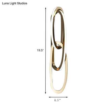 Modern gold wall lamp featuring minimalist interlocking oval rings ideal for living room lighting decor