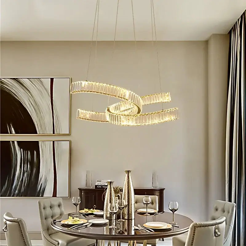 A modern gold pendant light with intertwined circular design and crystal led accents for dining room decorbites crystal led