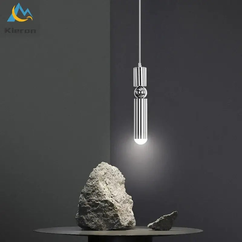 Modern gold iron art led pendant light with sleek chrome finish and cylindrical design featuring spherical accent