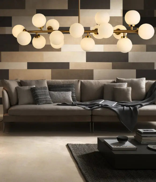 Modern gold island pendant light featuring a gold-toned chandelier with frosted glass globe lights for living rooms