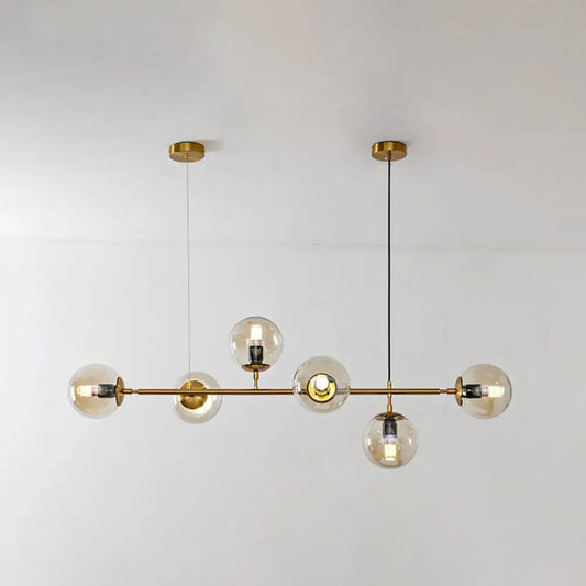 Modern gold island pendant light with brass chandelier design clear glass globe bulbs and black cords for dining room