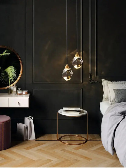 Modern gold k9 crystal linear kitchen pendant light with two faceted crystal shades and gold-toned metal fixtures emitting warm light 3200k