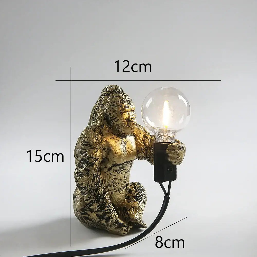 Modern gold king kong resin night light featuring a textured golden gorilla figurine holding a clear bulb for decorbites king kong