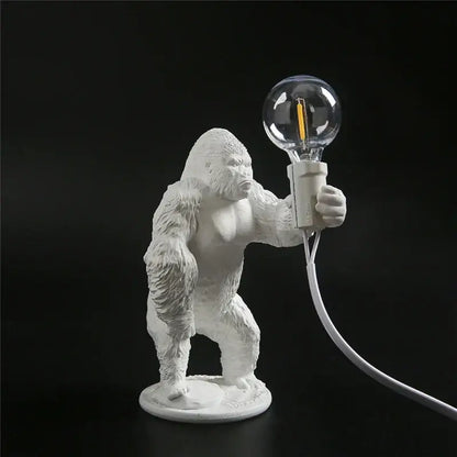 White ceramic king kong resin night light table lamp by decorbites holding a clear glass bulb for modern decor